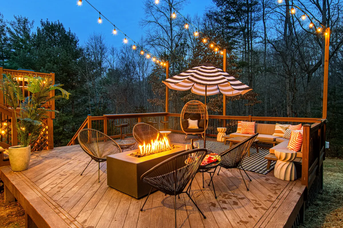 Lower deck fire pit and lounge seating at dusk – Asheville